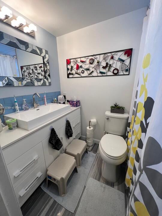 1500 South Ocean Boulevard, Unit 907 Pompano Beach, FL 33062 - Photo 9 of 14 a bathroom with a sink mirror vanity and toilet