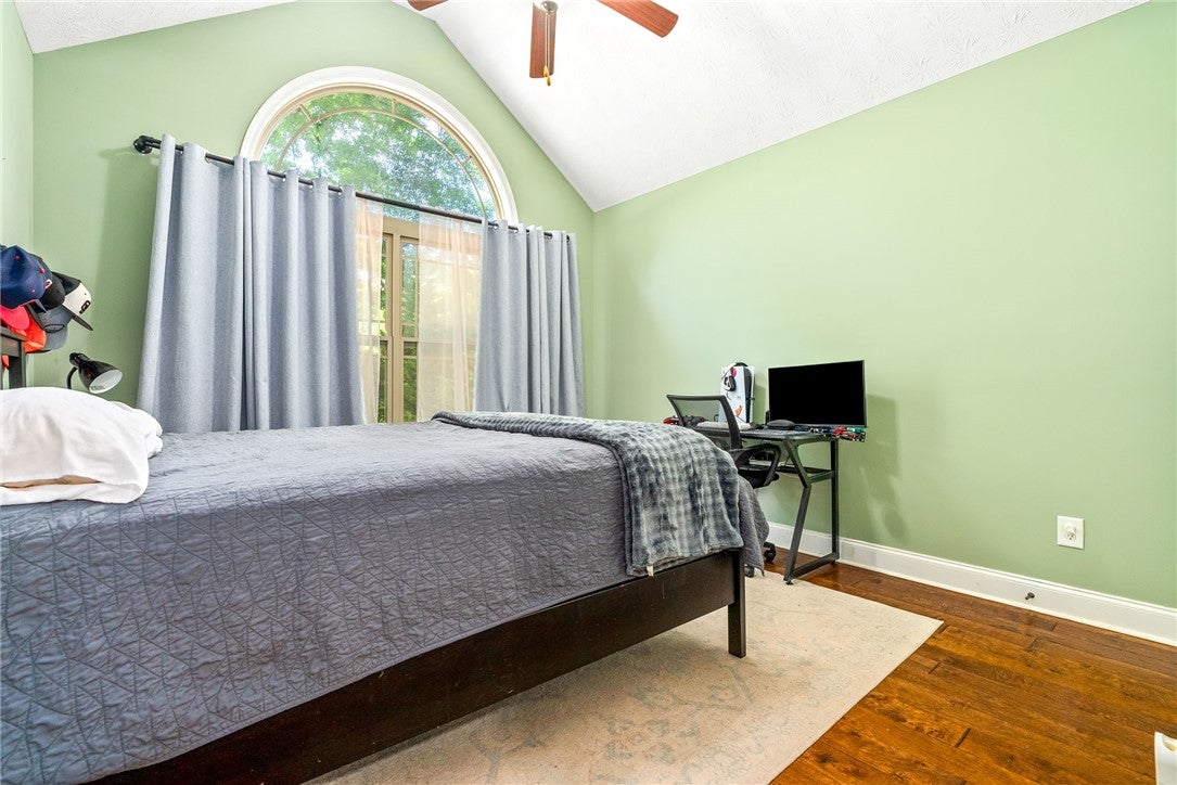 1284 Lee Road Salem, AL 36874 - Photo 17 of 24 This airy bedroom features high ceilings, rich hardwood floors, and abundant natural light.
