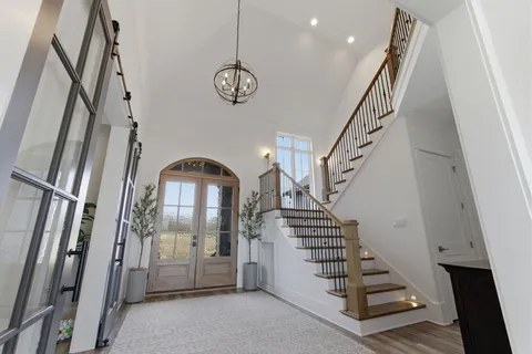 a large kitchen with a table and chairs in it