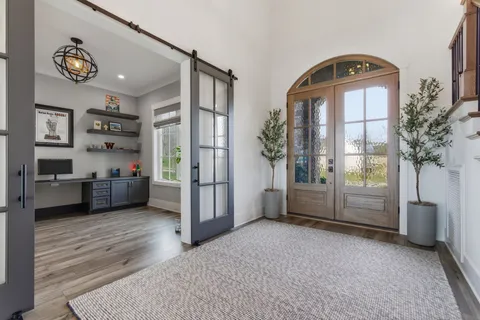 a living room with furniture a fireplace and a potted plant