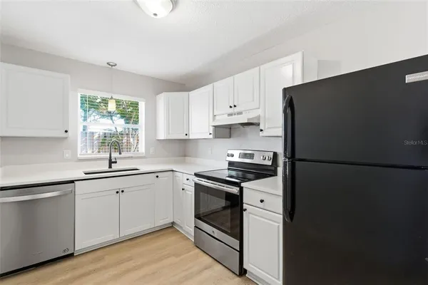 a kitchen with a white cabinets and white appliances