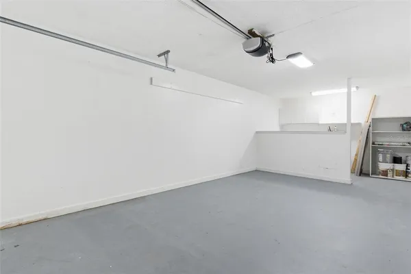 en empty room with ceiling fan and window