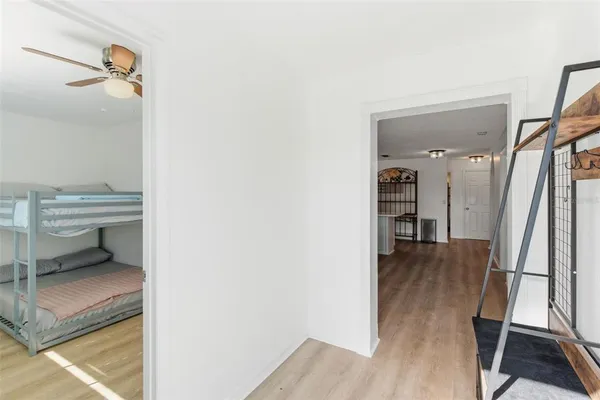 a view of a hallway and a livingroom with furniture