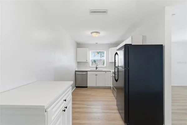 a kitchen with a refrigerator a sink and dishwasher