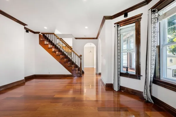a view of entryway and hall with wooden floor