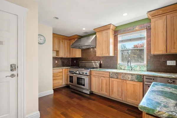 a kitchen with stainless steel appliances granite countertop a stove and a sink