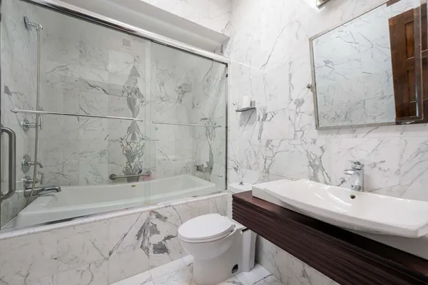 a bathroom with a sink a toilet and a bathtub