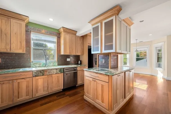 a kitchen with stainless steel appliances granite countertop a stove and a sink
