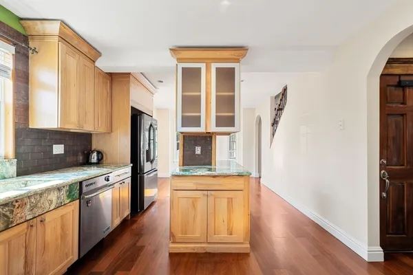 a kitchen with stainless steel appliances a stove a sink and a refrigerator