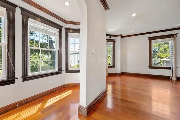 a view of an entryway with wooden floor and windows