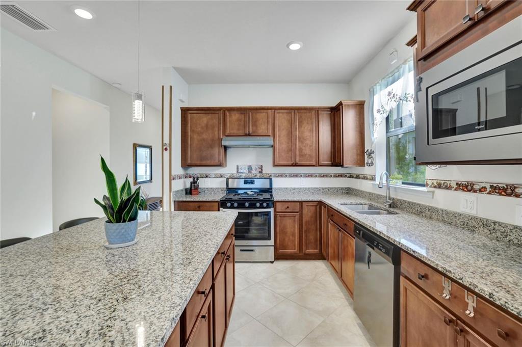 2171 Yellowfin Circle Naples, FL 34114 - Photo 1 of 38 a kitchen with a sink and counter space