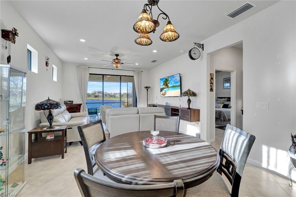 2171 Yellowfin Circle Naples, FL 34114 - Photo 11 of 38 a view of a dining room with furniture window and wooden floor
