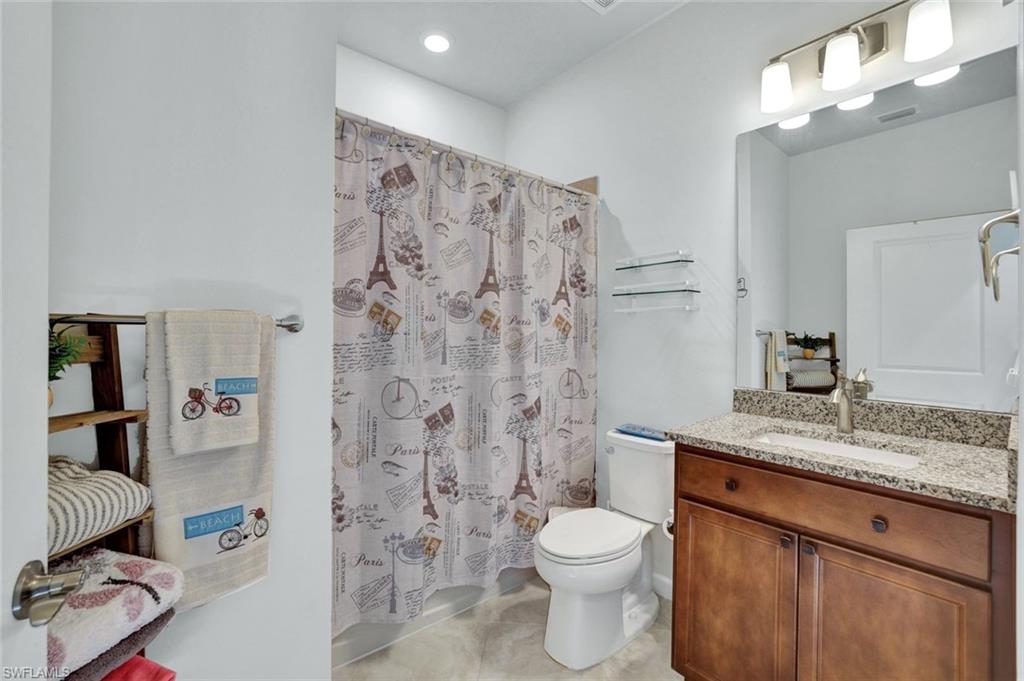 2171 Yellowfin Circle Naples, FL 34114 - Photo 18 of 38 a bathroom with a granite countertop sink toilet and shower