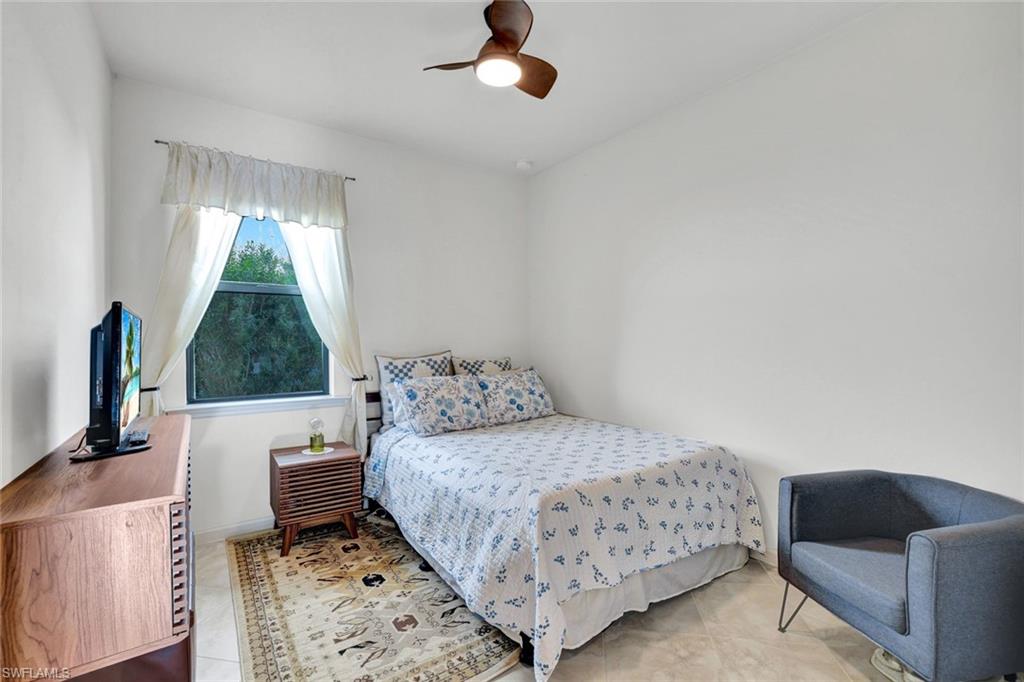2171 Yellowfin Circle Naples, FL 34114 - Photo 19 of 38 a bedroom with a bed and a couch