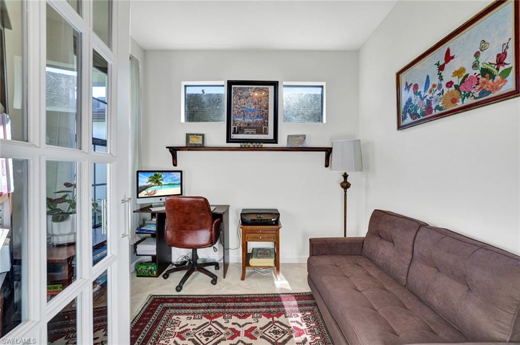 2171 Yellowfin Circle Naples, FL 34114 - Photo 21 of 38 a living room with furniture and a painting on the wall