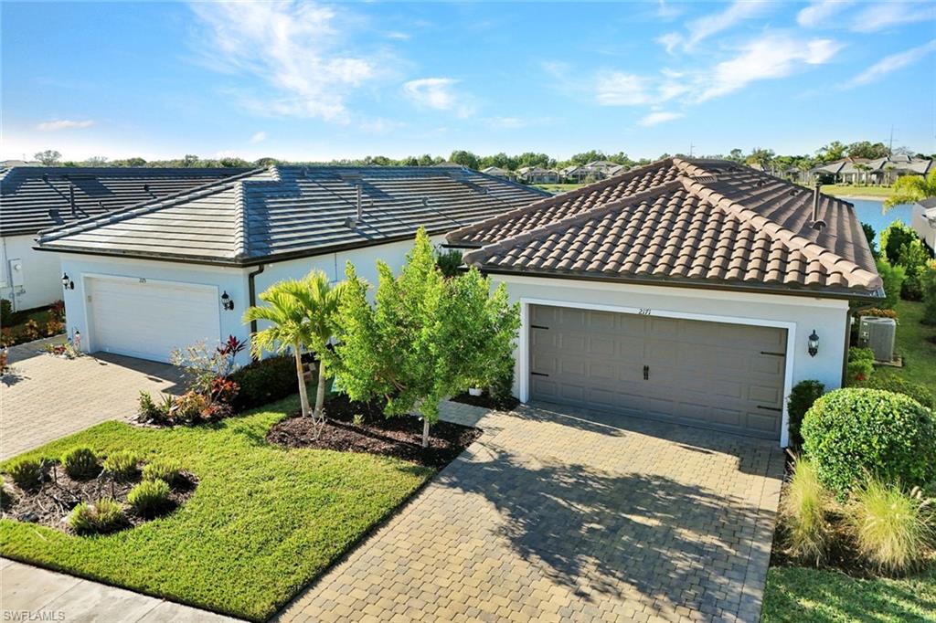 2171 Yellowfin Circle Naples, FL 34114 - Photo 24 of 38 a view of a house with a yard and sitting area
