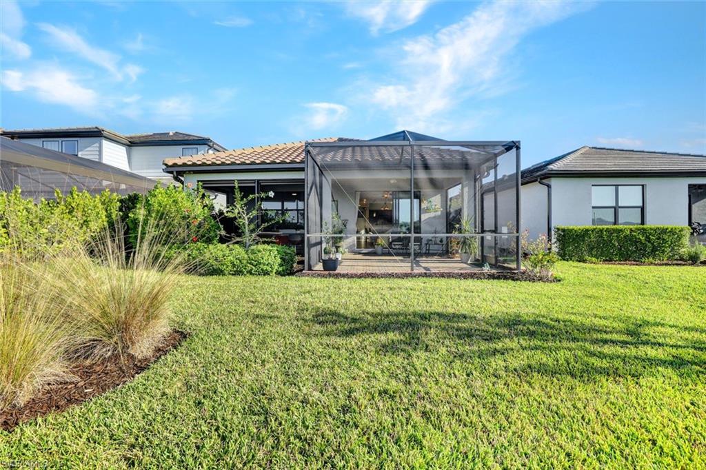 2171 Yellowfin Circle Naples, FL 34114 - Photo 27 of 38 a front view of house with yard and outdoor seating