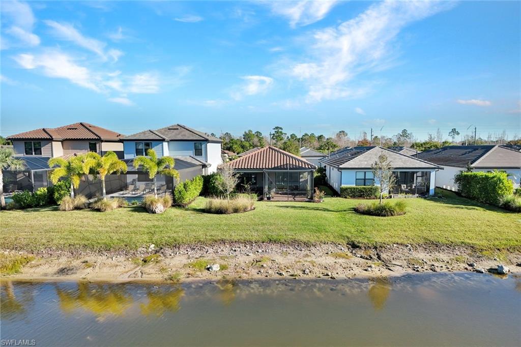 2171 Yellowfin Circle Naples, FL 34114 - Photo 28 of 38 a front view of a house with a yard and lake view