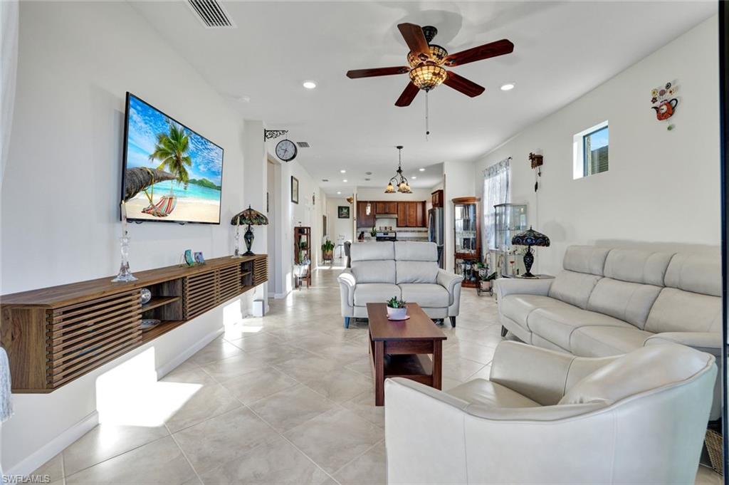 2171 Yellowfin Circle Naples, FL 34114 - Photo 10 of 38 a living room with furniture and a flat screen tv