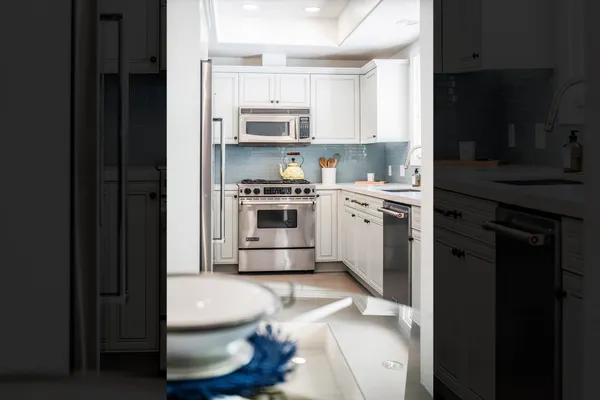 a kitchen with stainless steel appliances a stove a sink and a refrigerator