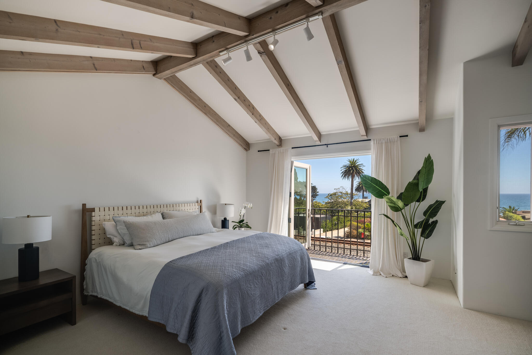 1647 Posilipo Lane, Unit B Montecito, CA 93108 - Photo 26 of 37 a bedroom with a large bed and a potted plant