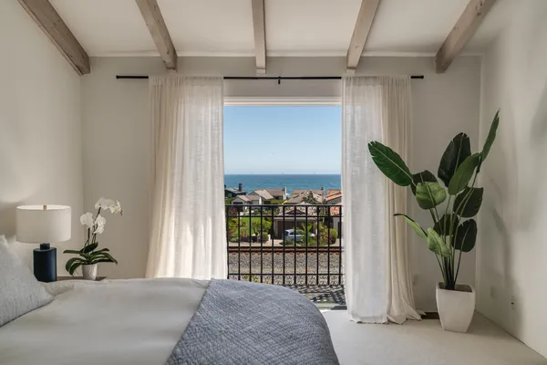 a room with a mirror on the wall and a window