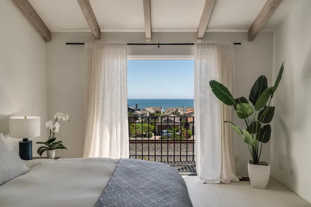 a room with a mirror on the wall and a window