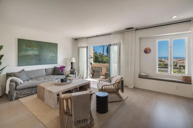 a work room with furniture and large windows