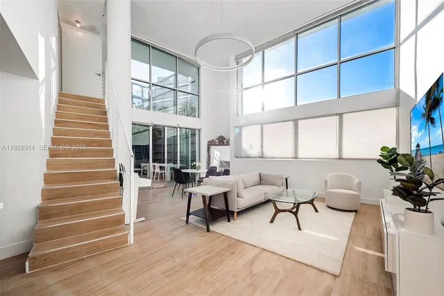 a living room with furniture windows and wooden floor