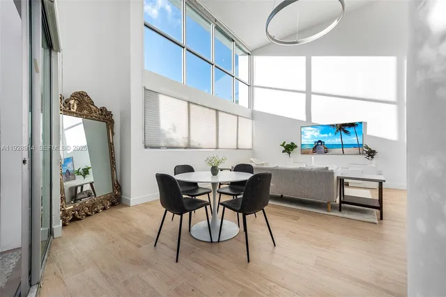 a view of a dining room with furniture window and wooden floor