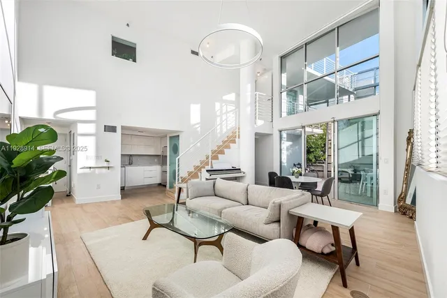 a living room with furniture a lamp and a potted plant