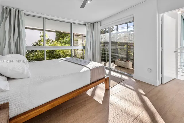 a bed sitting in a bedroom next to a window