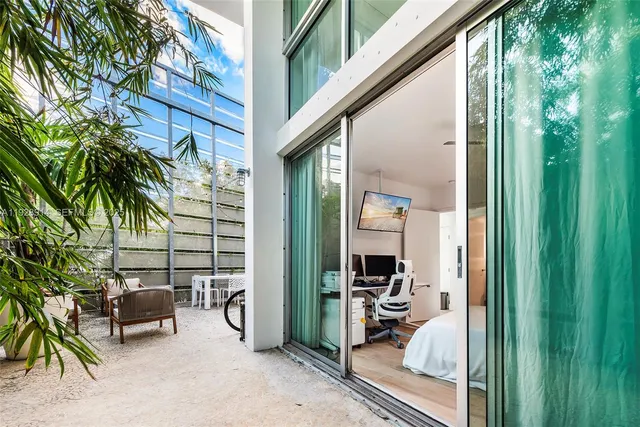 a balcony view with two chairs and a potted plant