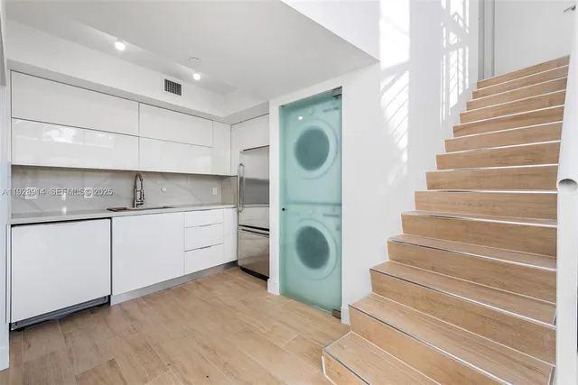 a view of entryway and hall with wooden floor