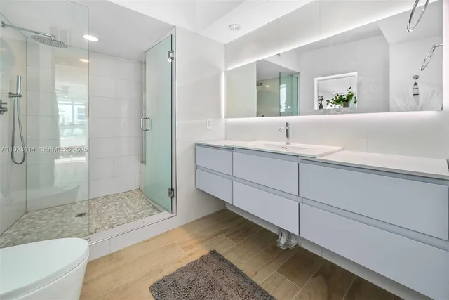 a bathroom with a tub shower and sink
