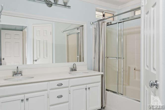 1159 Corto Street Simi Valley, CA 93065 - Photo 13 of 26 a bathroom with a shower sink and mirror