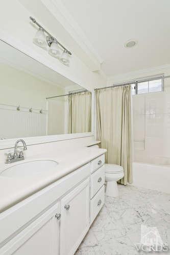 1159 Corto Street Simi Valley, CA 93065 - Photo 15 of 26 a bathroom with a double vanity sink a toilet and a tub