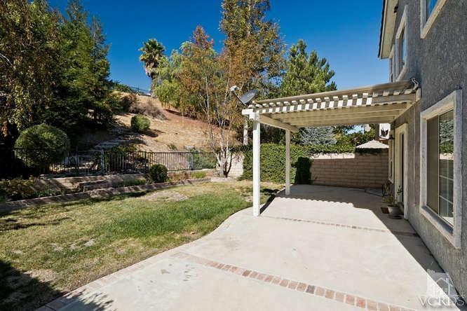 1159 Corto Street Simi Valley, CA 93065 - Photo 19 of 26 a view of a patio with table and chairs potted plants and floor to ceiling window
