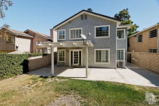 1159 Corto Street Simi Valley, CA 93065 - Photo 21 of 26 a front view of a house with a yard and garage