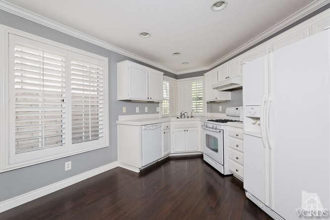 1159 Corto Street Simi Valley, CA 93065 - Photo 8 of 26 a kitchen with white cabinets and white appliances