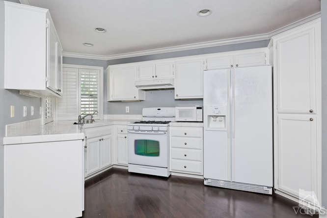 1159 Corto Street Simi Valley, CA 93065 - Photo 9 of 26 a kitchen with granite countertop white cabinets and white appliances