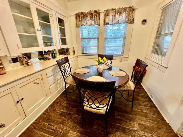 a view of a dining room with furniture a chandelier and wooden floor