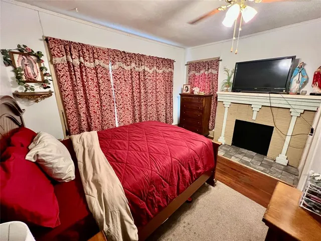 a bed room with a bed television and a fireplace