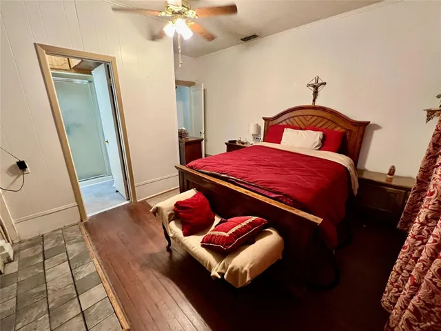 a bedroom with a bed and a mirror