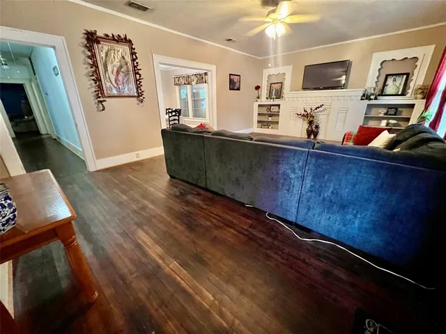 a living room with stainless steel appliances kitchen island granite countertop furniture and a flat screen tv