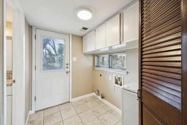 a view of a hallway to rooms and stairs