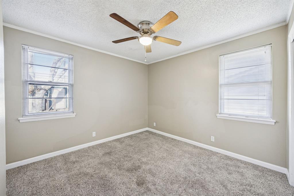 2017 Durham Street Irving, TX 75062 - Photo 15 of 26 an empty room with windows and ceiling fan