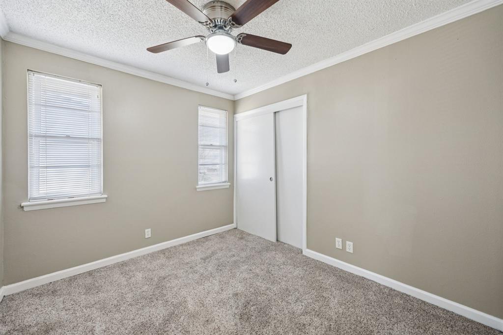 2017 Durham Street Irving, TX 75062 - Photo 16 of 26 an empty room with windows and fan