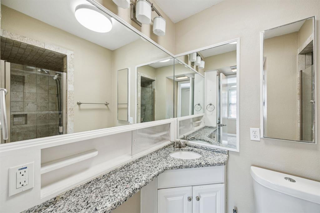 2017 Durham Street Irving, TX 75062 - Photo 18 of 26 a bathroom with a granite countertop sink mirror and vanity