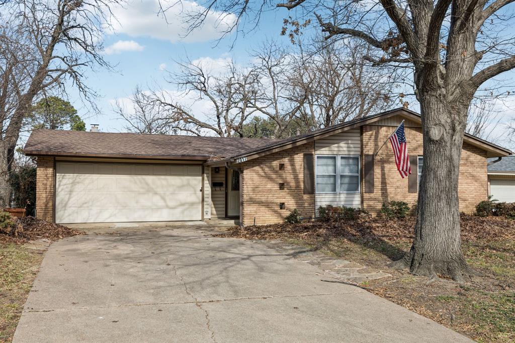 2017 Durham Street Irving, TX 75062 - Photo 2 of 26 a front view of a house with a yard and garage